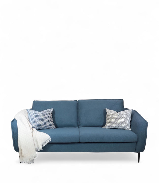 Cobalt Sofa in boucle-style blue fabric with slim black metal legs, rounded arms, and two patterned accent pillows, shown from front view and close-up fabric detail.