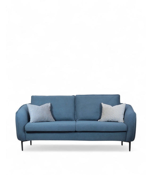 Cobalt Sofa in boucle-style blue fabric with slim black metal legs, rounded arms, and two patterned accent pillows, shown from front view and close-up fabric detail.