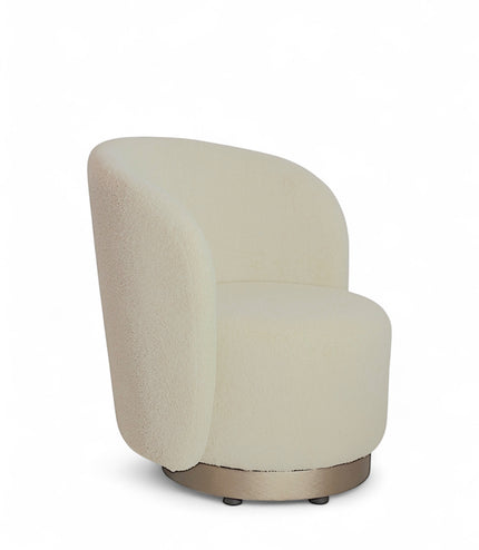 Modern boucle swivel lounge chair with off-white upholstery, curved backrest, and brass base by Vaya Home—ideal for contemporary living room or bedroom seating.
