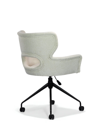 Wicky Swivel Chair in soft ivory boucle-style upholstery with sculptural cut-out backrest, flared arms, and black metal base on casters; shown in front three-quarter view.
