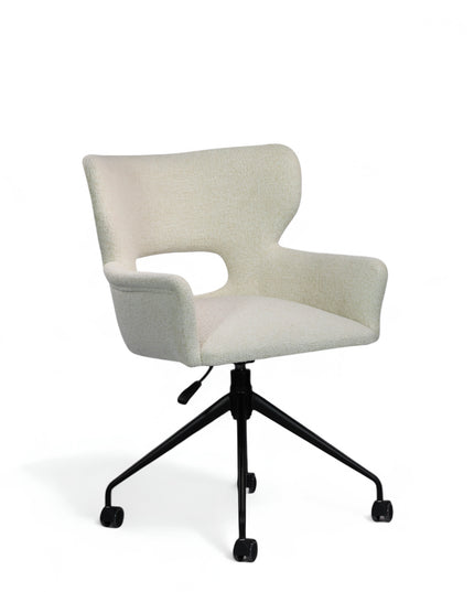 Wicky Swivel Chair in soft ivory boucle-style upholstery with sculptural cut-out backrest, flared arms, and black metal base on casters; shown in front three-quarter view.
