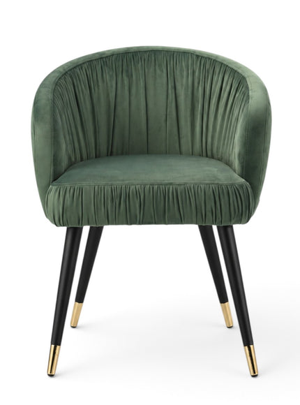 A green velvet barrel-style accent chair with black tapered legs and gold metal tips, shown against a plain white background.
