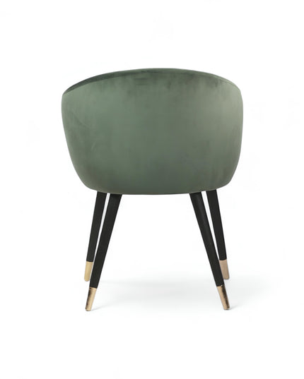 Modern forest green velvet barrel accent chair with pleated backrest and black metal legs with gold tips, perfect for living room or vanity seating.