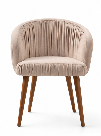 A modern barrel-style accent chair upholstered in a textured beige velvet fabric with a curved backrest and pleated detailing, supported by four tapered medium-brown wooden legs, shown on a clean white background.