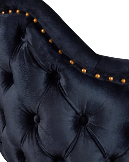 Dark blue velvet accent chair with tufted arm detailing and tapered wooden legs — ideal for modern dining rooms, vanity seating, or boutique interiors.