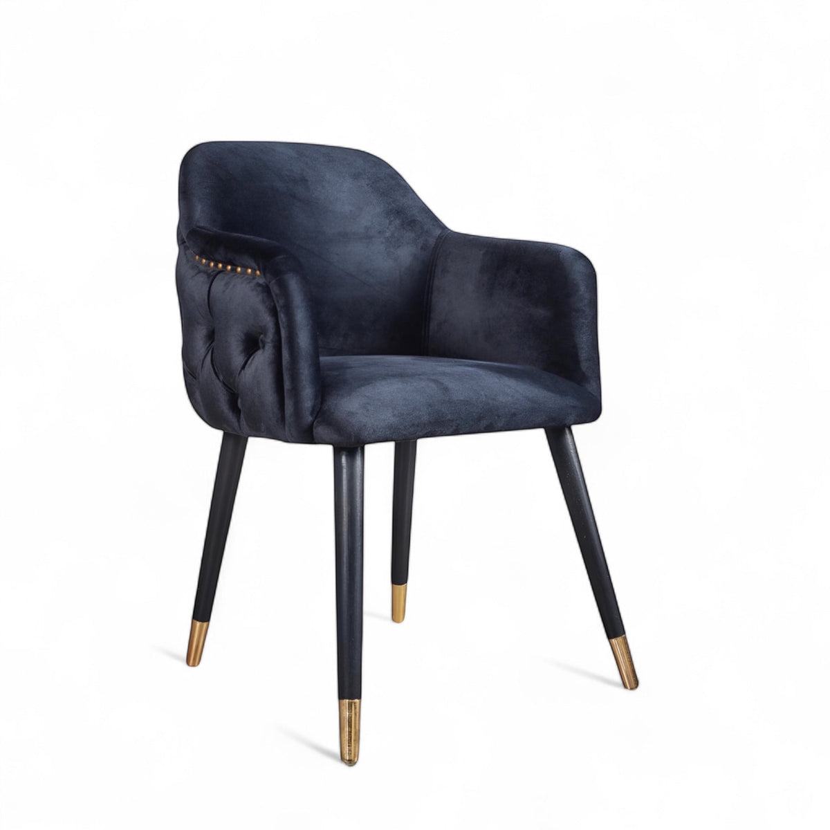 Dark blue velvet accent chair with tufted arm detailing and tapered wooden legs — ideal for modern dining rooms, vanity seating, or boutique interiors.