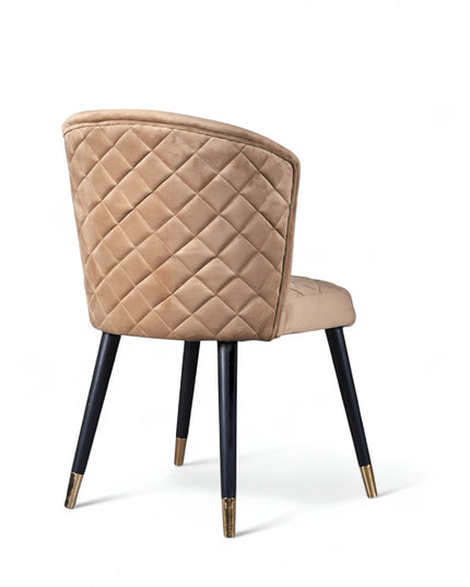 Elevate your interior with this diamond-stitched accent chair featuring a beige curved back, sleek black legs, and gold-tone accents—ideal for dining or vanity spaces.