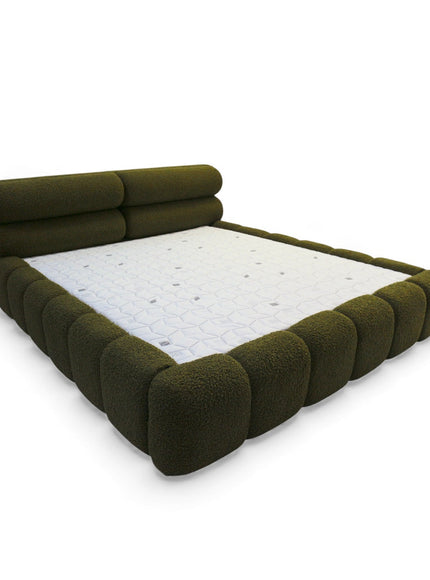 Green upholstered bed frame with white mattress on a white background