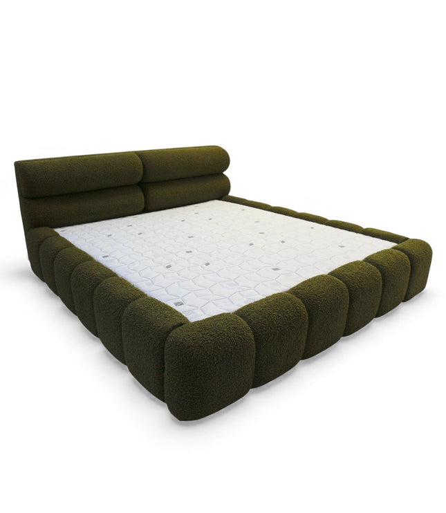Green upholstered bed frame with white mattress on a white background