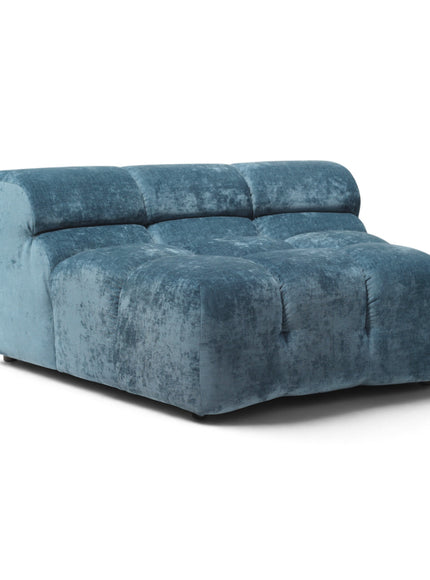 A modern modular lounge chair in distressed blue velvet, featuring a tufted seat and back cushions, photographed on a clean white background.