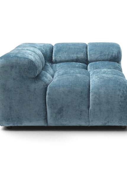 A modern modular tufted sofa upholstered in textured blue velvet, shown from a front-facing perspective on a clean white background.