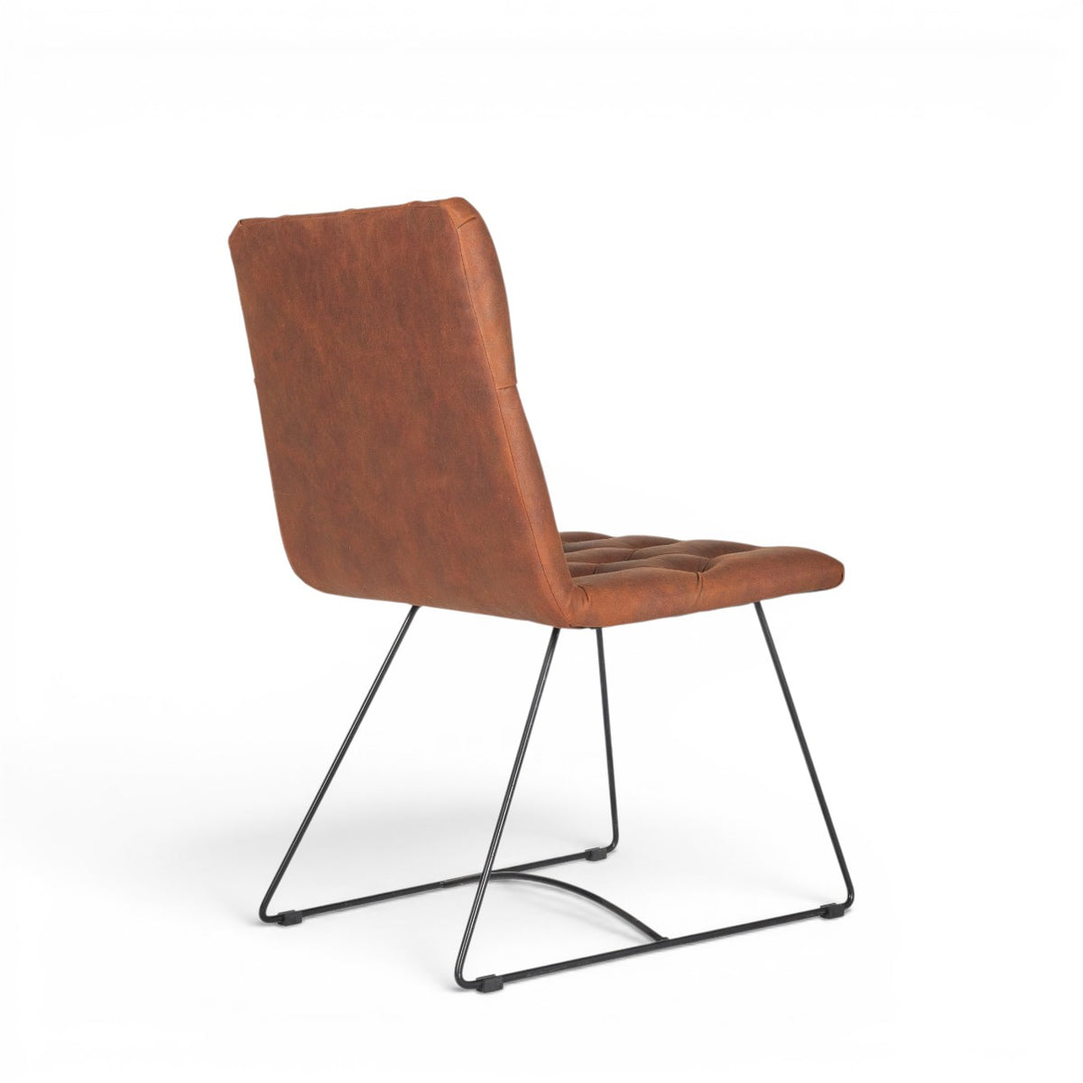 Rear angled view of the Vaya Home Hudson dining chair with brown faux leather upholstery and black metal sled base.