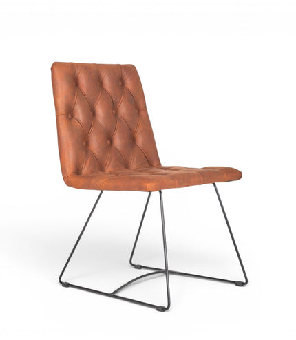 Vaya Home Hudson dining chair with brown faux leather upholstery, button-tufted seat and back, and black metal sled legs.