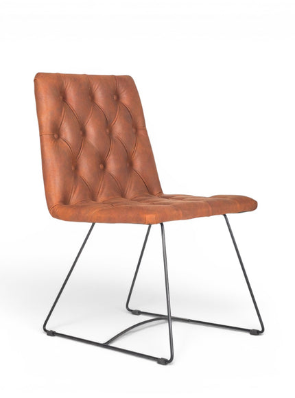 Vaya Home Hudson dining chair with brown faux leather upholstery, button-tufted seat and back, and black metal sled legs.