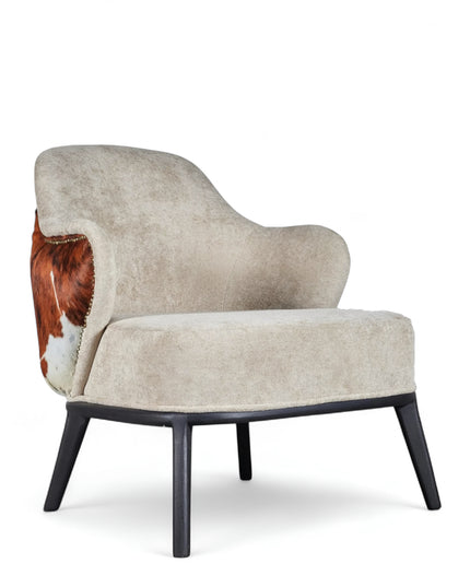 Kalv Armchair with beige fabric front, cowhide-style back panel, brass nailhead trim, and black tapered legs; shown from side, angled front, and rear views.
