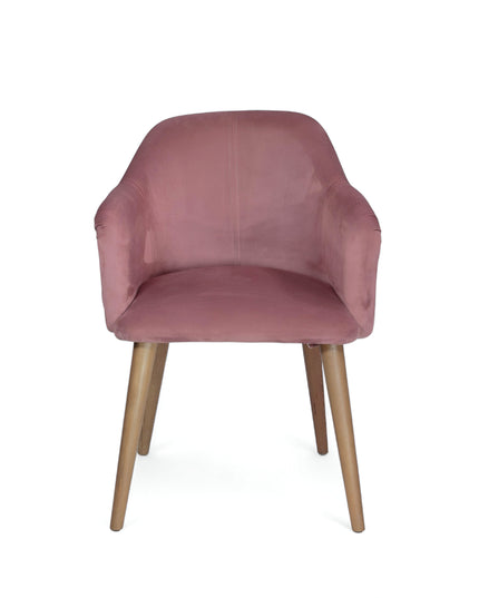 Blush pink velvet accent chair with tufted arm detailing and tapered wooden legs — ideal for modern dining rooms, vanity seating, or boutique interiors.