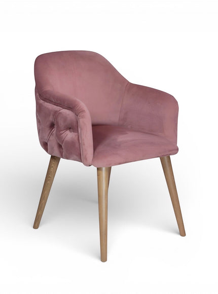Pink velvet chair with wooden legs on a white background