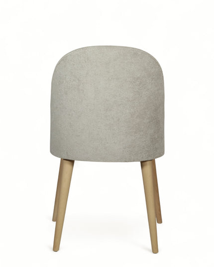 Contemporary beige chair with rounded backrest, cushioned seat, and tapered wooden legs