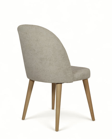 Contemporary beige chair with rounded backrest, cushioned seat, and tapered wooden legs
