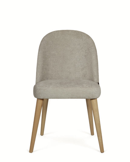 Contemporary beige chair with rounded backrest, cushioned seat, and tapered wooden legs