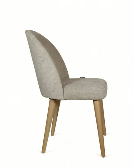 Contemporary beige chair with rounded backrest, cushioned seat, and tapered wooden legs