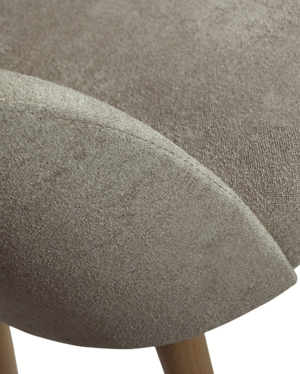 Contemporary beige chair with rounded backrest, cushioned seat, and tapered wooden legs