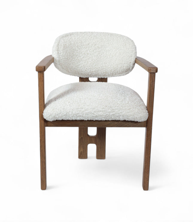 Mid-century modern dining chair with a solid wood frame and white boucle upholstered seat and curved backrest