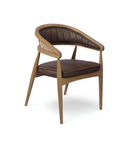  Mid-century modern accent chair with curved oak frame, woven cane side panels, and dark brown faux leather upholstery, ideal for dining rooms or stylish home offices.