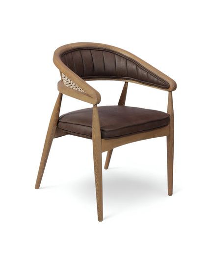  Mid-century modern accent chair with curved oak frame, woven cane side panels, and dark brown faux leather upholstery, ideal for dining rooms or stylish home offices.