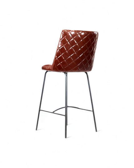 Modern bar stool with glossy dark brown faux leather upholstery, quilted side detailing, and slender black metal legs with a footrest, ideal for kitchen islands or contemporary home bars