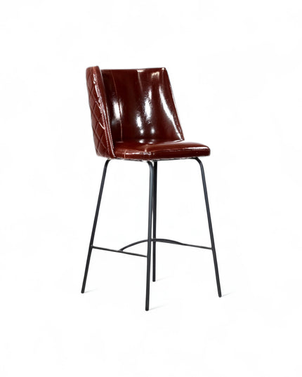 Modern bar stool with glossy dark brown faux leather upholstery, quilted side detailing, and slender black metal legs with a footrest, ideal for kitchen islands or contemporary home bars
