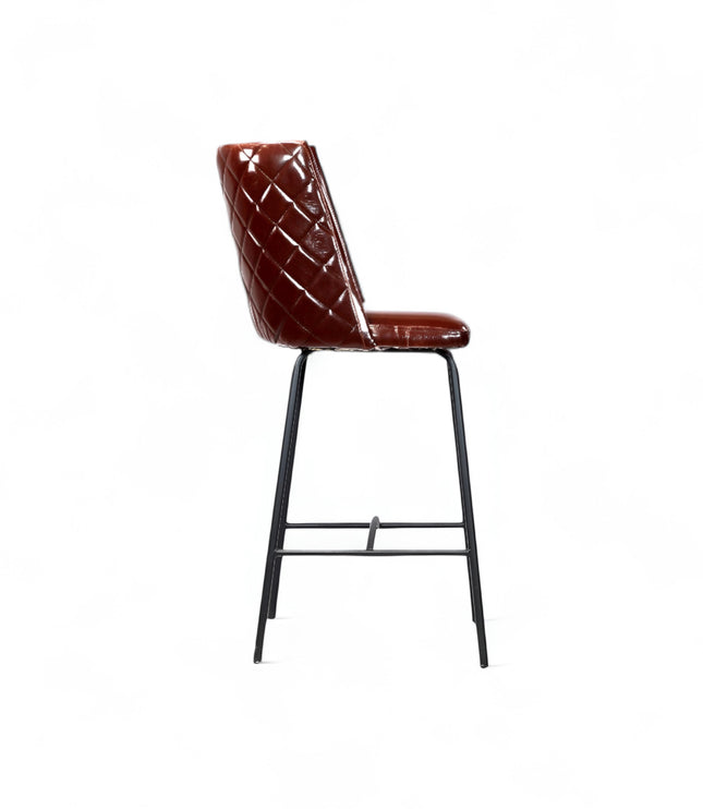 Modern bar stool with glossy dark brown faux leather upholstery, quilted side detailing, and slender black metal legs with a footrest, ideal for kitchen islands or contemporary home bars