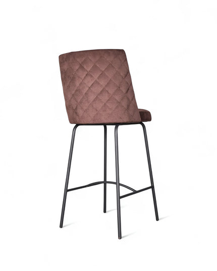 Modern bar stool with brown upholstery, quilted side detailing, and slender black metal legs with a footrest, ideal for kitchen islands or contemporary home bars