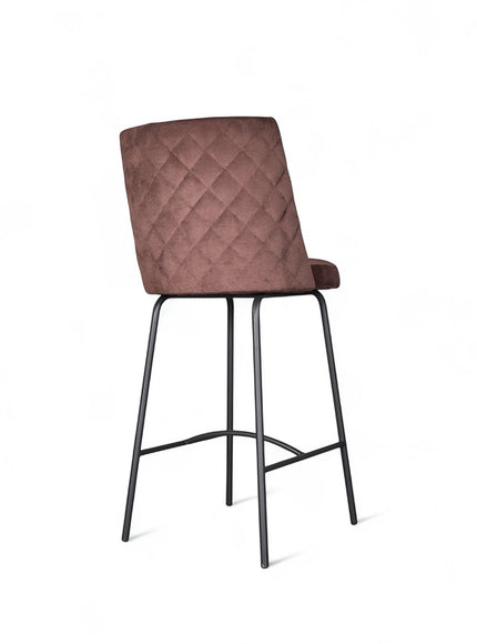 Modern bar stool with brown upholstery, quilted side detailing, and slender black metal legs with a footrest, ideal for kitchen islands or contemporary home bars