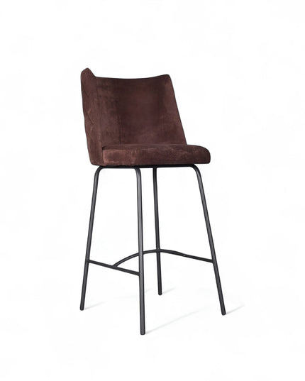 Modern bar stool with brown upholstery, quilted side detailing, and slender black metal legs with a footrest, ideal for kitchen islands or contemporary home bars