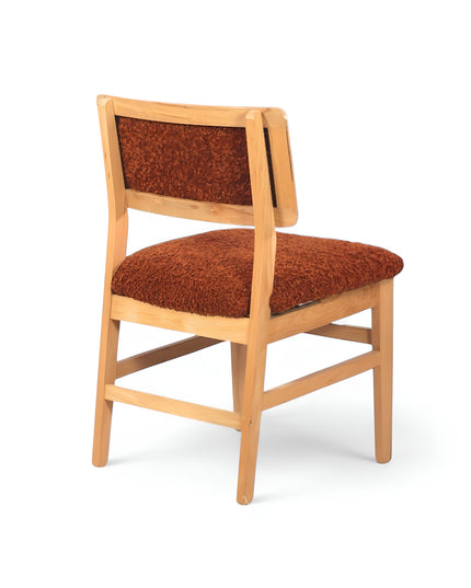 Rustic accent chair with burnt orange shearling-style upholstery and natural wood frame, ideal for modern farmhouse or boho interiors.