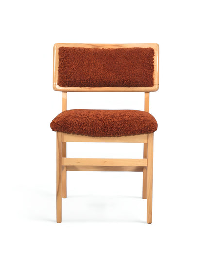 Rustic accent chair with burnt orange shearling-style upholstery and natural wood frame, ideal for modern farmhouse or boho interiors.