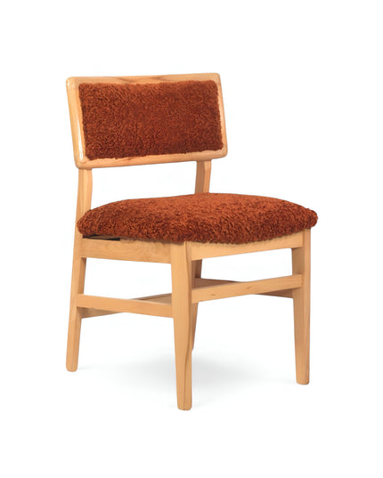 Rustic accent chair with burnt orange shearling-style upholstery and natural wood frame, ideal for modern farmhouse or boho interiors.