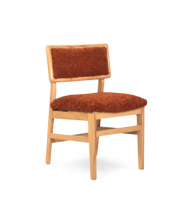 Rustic accent chair with burnt orange shearling-style upholstery and natural wood frame, ideal for modern farmhouse or boho interiors.