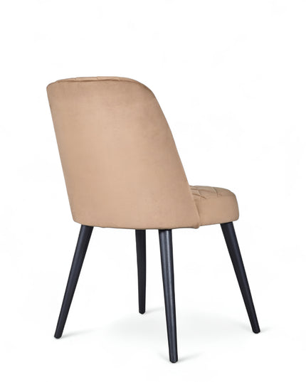 Modern armless beige dining chair with cushioned seat, curved backrest, and black metal legs