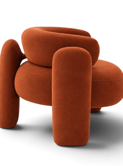 A modern, rounded accent chair upholstered in a textured burnt orange velvet fabric, shown from a front-facing perspective on a clean white background.