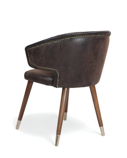 Vintage-style barrel accent chair with distressed brown faux leather upholstery and gold-tipped wooden legs, ideal for rustic or industrial interiors.