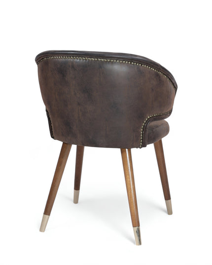 Vintage-style barrel accent chair with distressed brown faux leather upholstery and gold-tipped wooden legs, ideal for rustic or industrial interiors.
