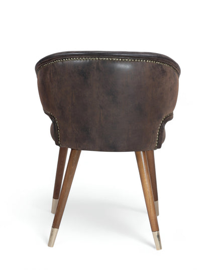 Vintage-style barrel accent chair with distressed brown faux leather upholstery and gold-tipped wooden legs, ideal for rustic or industrial interiors.