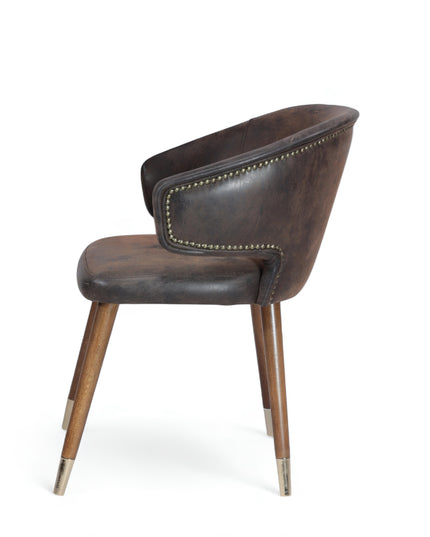 Vintage-style barrel accent chair with distressed brown faux leather upholstery and gold-tipped wooden legs, ideal for rustic or industrial interiors.