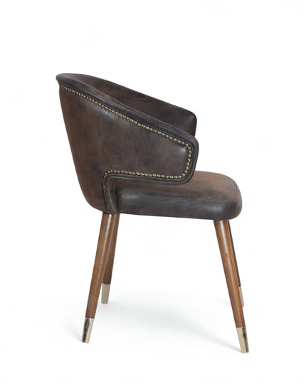 Vintage-style barrel accent chair with distressed brown faux leather upholstery and gold-tipped wooden legs, ideal for rustic or industrial interiors.
