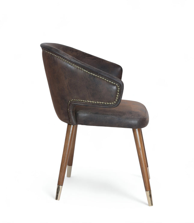Vintage-style barrel accent chair with distressed brown faux leather upholstery and gold-tipped wooden legs, ideal for rustic or industrial interiors.