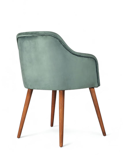 Upholstered green armchair with diamond stitching, enclosed sides, and tapered wooden legs