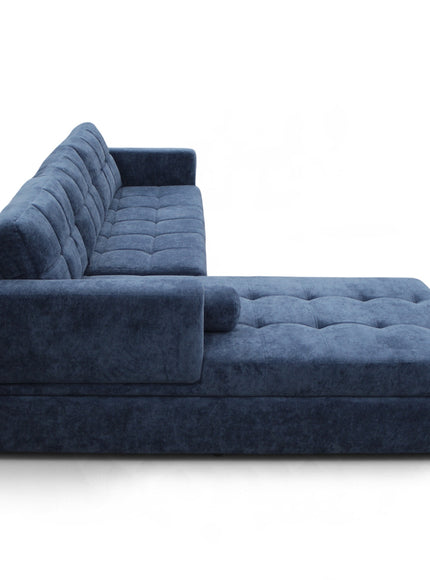 A modern sectional sofa with a chaise lounge, upholstered in a textured navy blue velvet fabric, shown from a side profile view on a white background.
