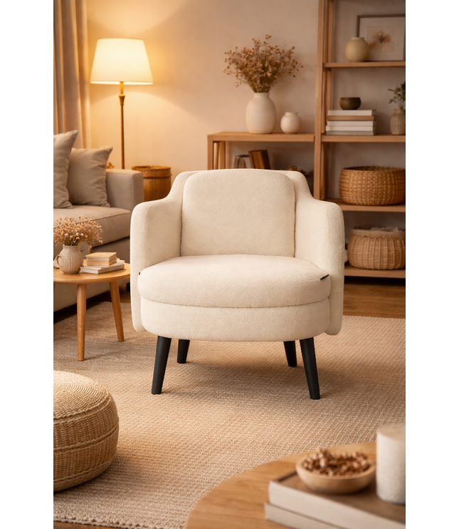 Beige armchair in a cozy living room with books and decor.